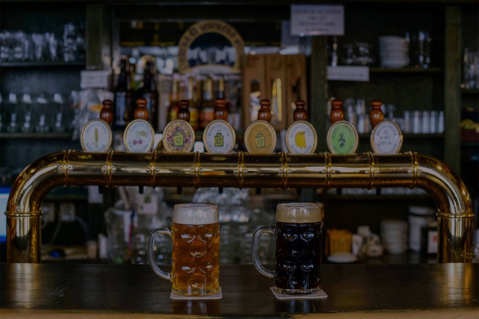 The bar at Pivovarský dům, with the tap and two filled glasses of beer.
